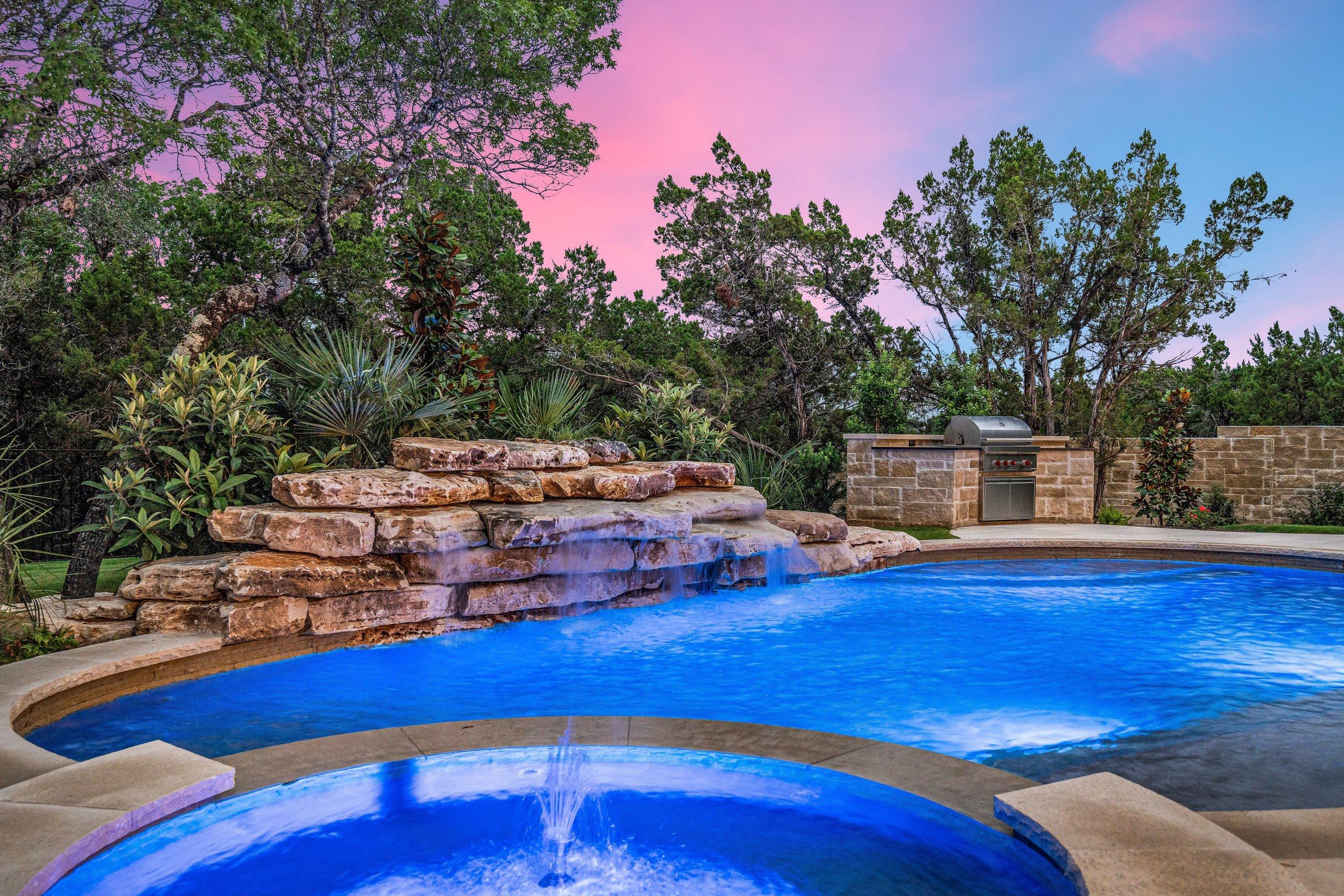 Pool and heated spa at 4300 Amarra Drive at twilight